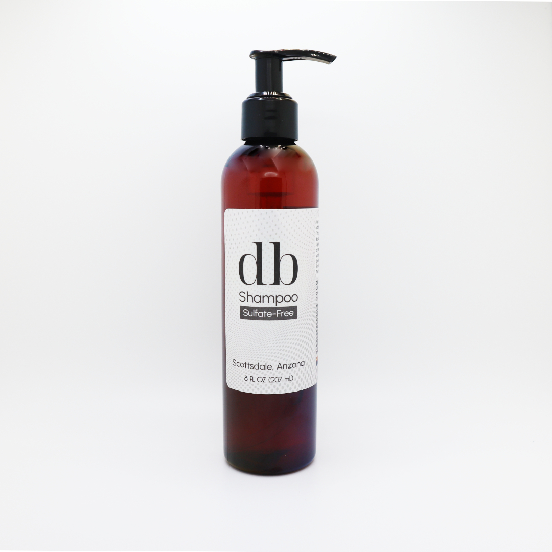 db Sulfate-Free Shampoo in amber pump bottle against white backdrop.